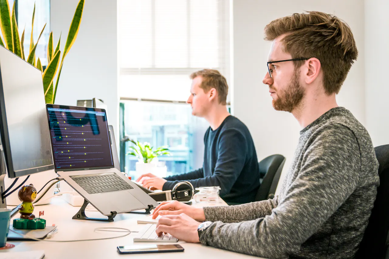 Software engineers working side by side at their computers