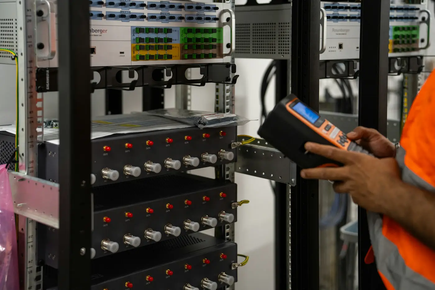 A technician checking network equipment in a server rack