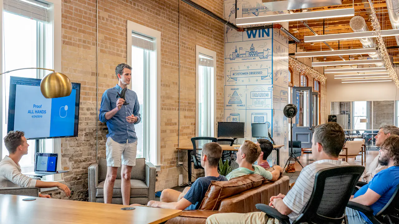 A presenter sharing ideas with a team in a bright, open office
